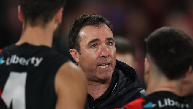 MELBOURNE, AUSTRALIA - AUGUST 16: Brad Scott, Senior Coach of the Bombers speaks to the team during the round 23 AFL match between Essendon Bombers and Sydney Swans at Marvel Stadium, on August 16, 2024, in Melbourne, Australia. (Photo by Daniel Pockett/Getty Images)