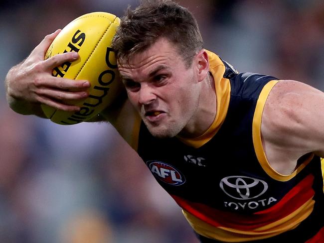 ADELAIDE, AUSTRALIA - SEPTEMBER 19: Brad Crouch of the Crows is tackled by Daniel Rioli of the Tigers during the 2020 AFL Round 18 match between the Adelaide Crows and the Richmond Tigers at Adelaide Oval on September 19, 2020 in Adelaide, Australia. (Photo by James Elsby/AFL Photos via Getty Images)