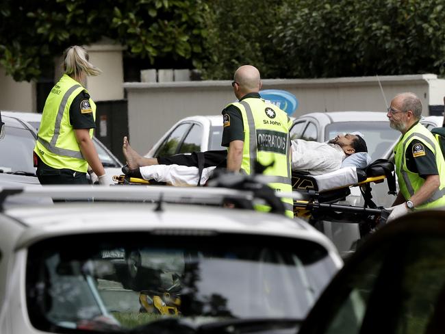 Ambulance staff take a man from outside a mosque in central Christchurch, New Zealand. Picture: AP