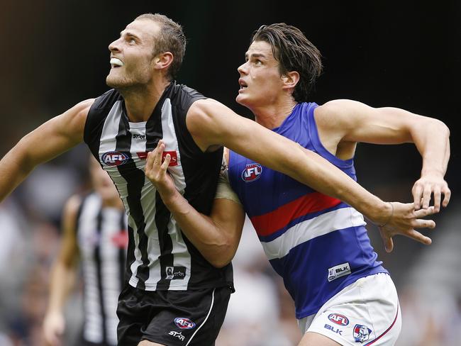 NAB Challenge AFL : Double Header. Collingwood vs Western Bulldogs at Etihad Stadium. Tom Boyd contests a boundary throw in with Jarrod Witts . Pic: Michael Klein.