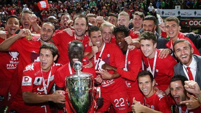 Adelaide United players celebrate their FFA Cup win at Coopers Stadium. Photo Sarah Reed.