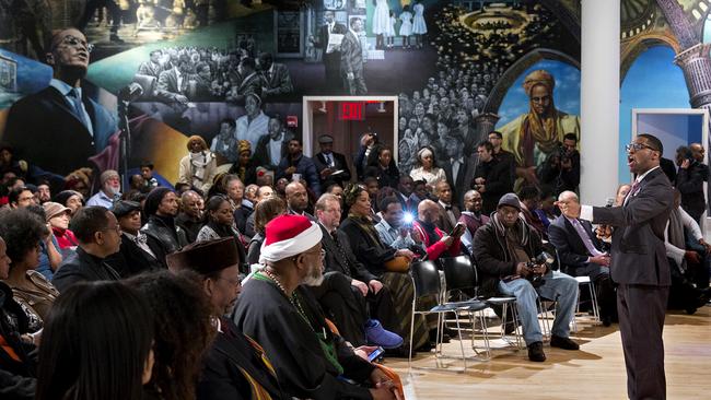 A mural depicting the lives of Malcolm X and his family is the backdrop for artist Jamel Hudson as he sings as family, activists, actors, and politicians remember the civil rights leader. Hudson stands within feet of where Malcolm X fell. Picture: AP