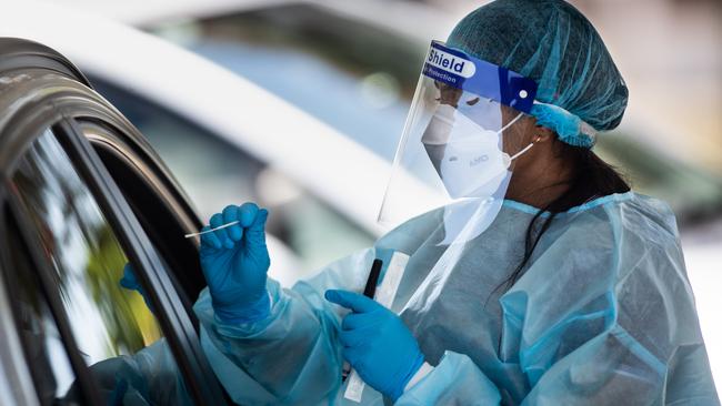 A nurse conducts a rapid antigen test at a drive-through clinic in Sydney. Picture: Julian Andrews