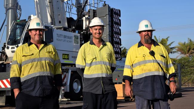 Tutt Bryant crane operators Heath Lowman, Michael Woods and Alex Wilson stand in front of the Territory's tallest crane. Picture: Sierra Haigh