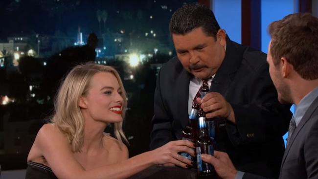 Cheers! Margot Robbie shows off her beer-busting skills.