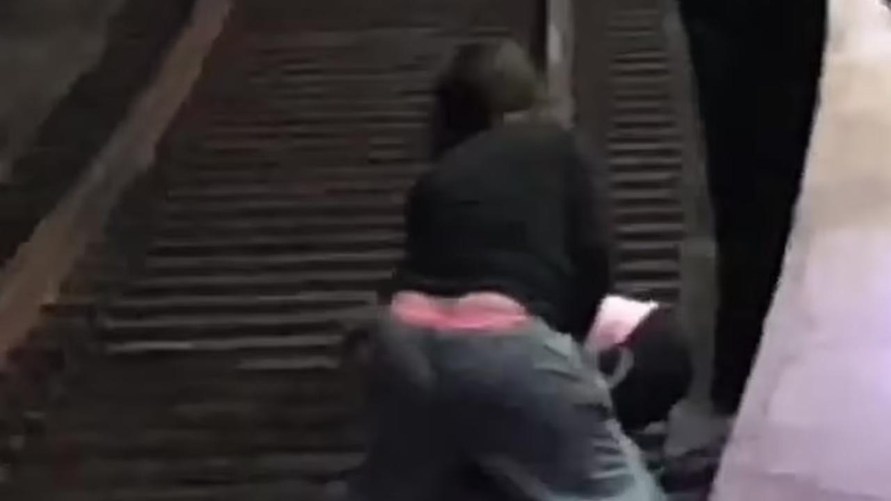 The woman was praised as a hero for risking her life to save the elderly man, who appeared unconscious after falling off the platform and hitting his head. Picture: Reddit