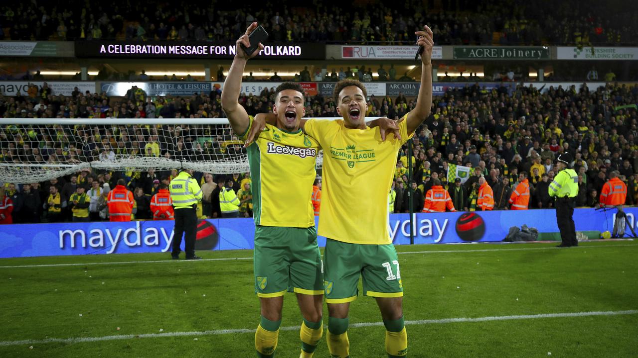 Norwich City's Ben Godfrey, left, and Norwich City's Jamal Lewis celebrate promotion to the Premier League