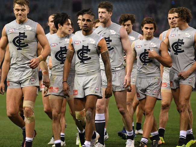 Patrick Cripps (left) leads the Blues from the field after the Round 17