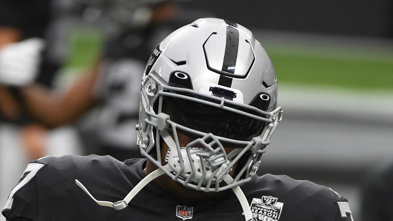 Raiders offensive tackle Trent Brown wears a helmet featuring a raised fist design.