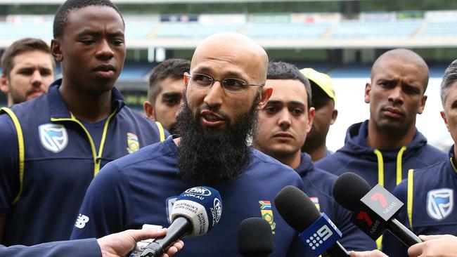 Hashim Amla, with support from the entire South African team, fronts the media.