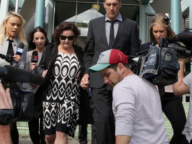 Julie Goodwin (centre) and her husband Mick surrounded by media at Gosford Court. Picture: Mark Scott