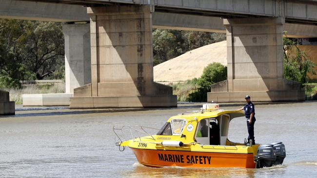 Marine officers search the river near the bridge for the man. Pic: Calum Robertson