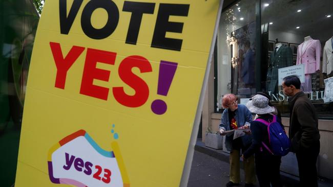 A Yes23 campaigner hands out pamphlets outside a polling centre in the central business district.