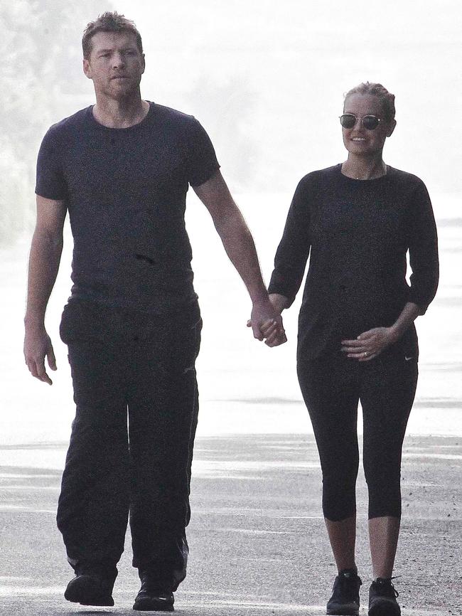 A heavily pregnant Lara takes a stroll with Sam in Malibu.