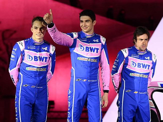 (From L) Alpine F1 team's drivers, Australian Oscar Piastri, French Esteban Ocon and Spanish Fernando Alonso, pose during the unveiling of Alpine F1 team's A522 new racing car for the upcoming Formula One 2022 season at the Palais de Tokyo in Paris on February 21, 2022, two days before the first pre-season track session of the year at the Circuit de Barcelona-Catalunya. - The A522 will be raced this year by Fernando Alonso and Esteban Ocon, whoâll team up for a second season at Alpine. (Photo by FRANCK FIFE / AFP)