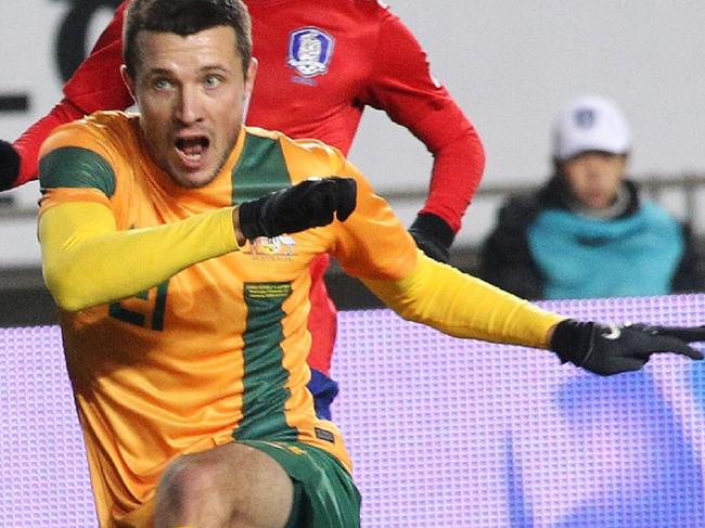 14/11/2012 WIRE: Australia's Nikita Rukavytsya, center, scores a goal as South Korea's Kim Young-gown, right, and Lee Seung-gi look on during their friendly soocer match in Hwaseong, South Korea, Wednesday, Nov. 14, 2012. (AP Photo/Ahn Young-joon) Pic. Ap