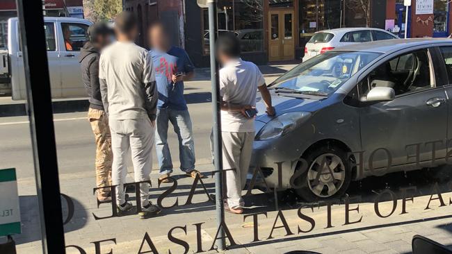 Uber Eats drivers parked on Elizabeth St, outside Taste of Asia, waiting for an order.