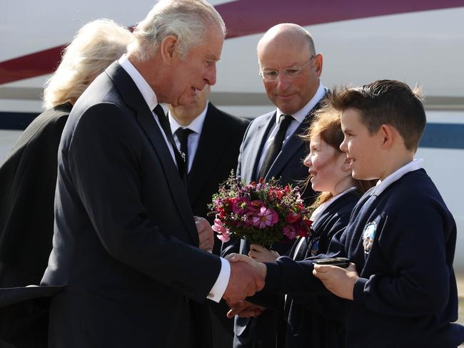 King Charles III is greeted by Ella Smith aged 10, and Lucas Watt aged 10 as he arrives at Belfast City Airport in Northern Ireland. Picture: Getty