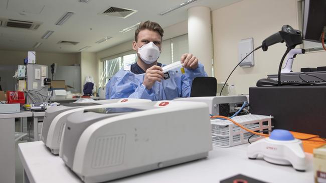 Dr Mathew Mooney with the Biofire machine that can test athletes for a dozen or so infectious diseases. Picture: Gary Ramage