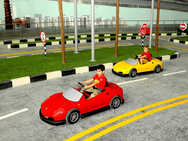 <p>Junior GT is a driving school for children with instructions from experts and a ride in a scaled-down 430 GT Spider. Picture: Ferrari World</p>