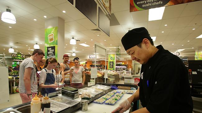 Suhi Izu staff stocking the sushi bar inside Woolworths supermarket at Gasworks.Steve Chen making Sushi. Pic Annette Dew