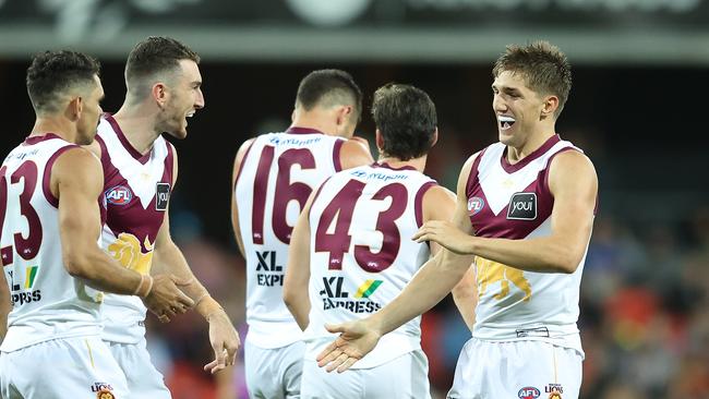 Zac Bailey (right) is congratulated by his Brisbane Lions teammates during the QClash. Picture: Chris Hyde/Getty Images