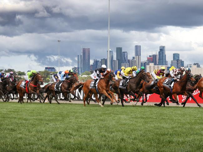 2022 Lexus Melbourne Cup race. The riders and horses bunch up down the straight after the start.                       Picture: David Caird