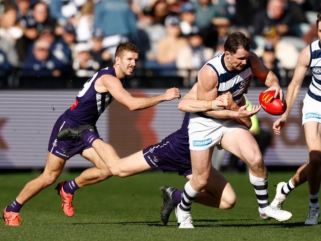 Patrick Dangerfield of the Cats is tackled by Hayden Young. Picture: Michael Willson/AFL Photos via Getty Images.