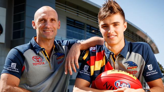 SON OF A GUN: Crows father-son draft pick Jackson Edwards with his dad Tyson yesterday. Picture: Matt Turner.