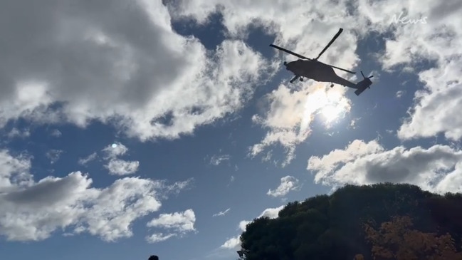 Commander Alastair Walsh in navy chopper landing at The Hutchins School