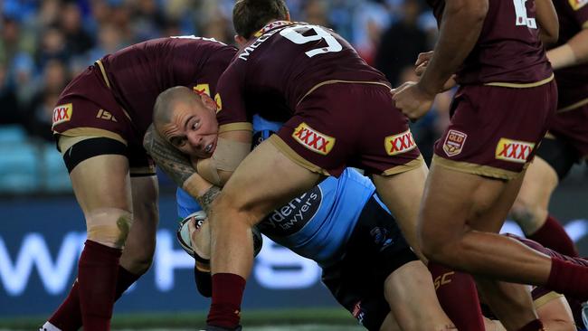 David Klemmer is wrapped up by Queensland defenders. Photo: Adam Head