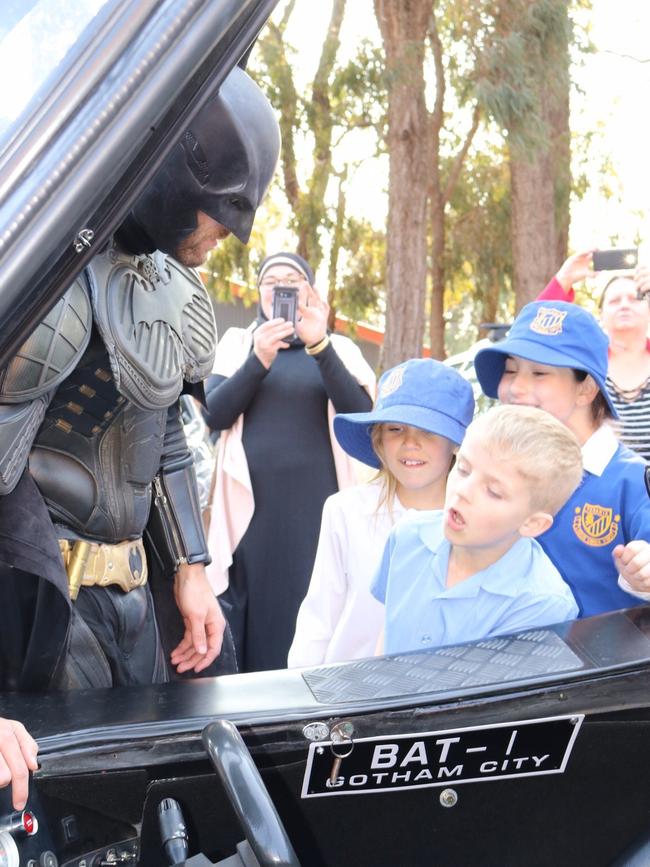 Finn and his friends check out the Batmobile.