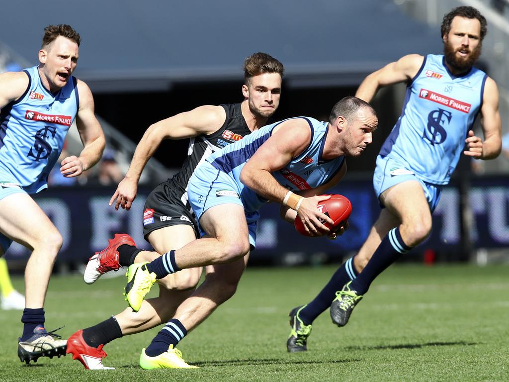 Zane Kirkwood runs forward with Will Snelling in pursuit.