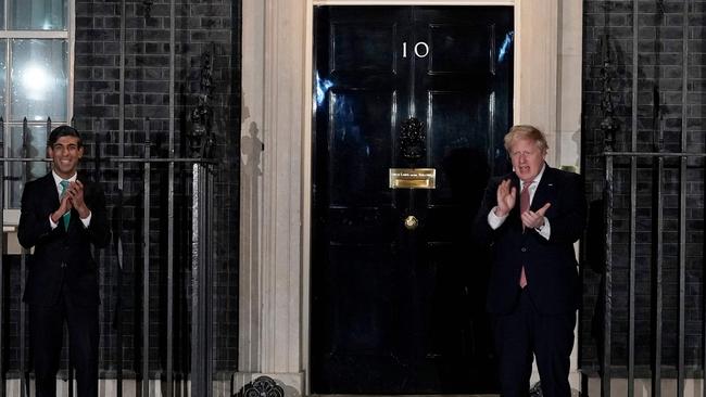 Boris Johnson, right, and Chancellor of the Exchequer Rishi Sunak applaud on the step of 10 Downing Street in appreciation of the National Health Service (NHS) ahead of Johnson’s diagnosis. Picture: Andrew Parsons/10 Downing Street/AFP