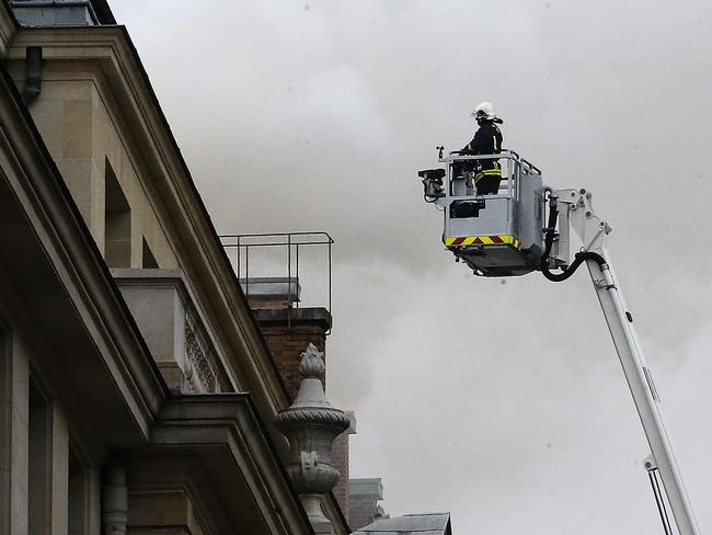 A French firefighter stands atop a fire ladder as a fire engulfed the top floor of Paris’ Ritz Carlton hotel, Tuesday, Jan. 19, 2016 in Paris. The hotel has been closed for renovations for three years and was expected to re-open in March, restored to the grandeur that drew the likes of Frederic Chopin, Coco Chanel and Ernest Hemingway. (AP Photo/Jacques Brinon)