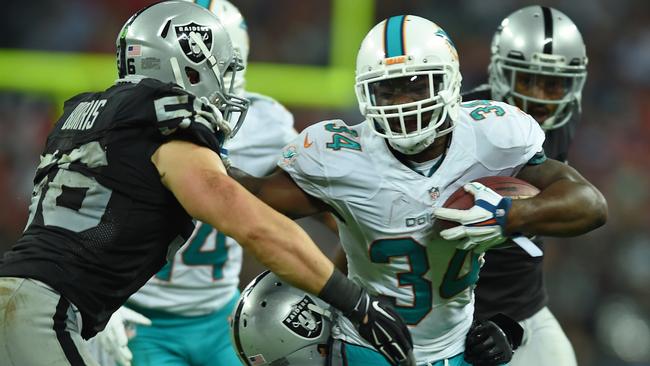 Miami Dolphins' Damien Williams is tackled at Wembley.