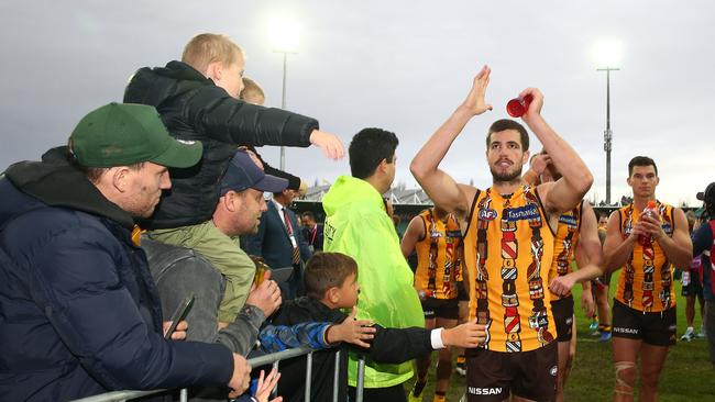 Ben Stratton leads Hawthorn off after its victory over Port Adelaide. Picture: Scott Barbour/Getty Images.