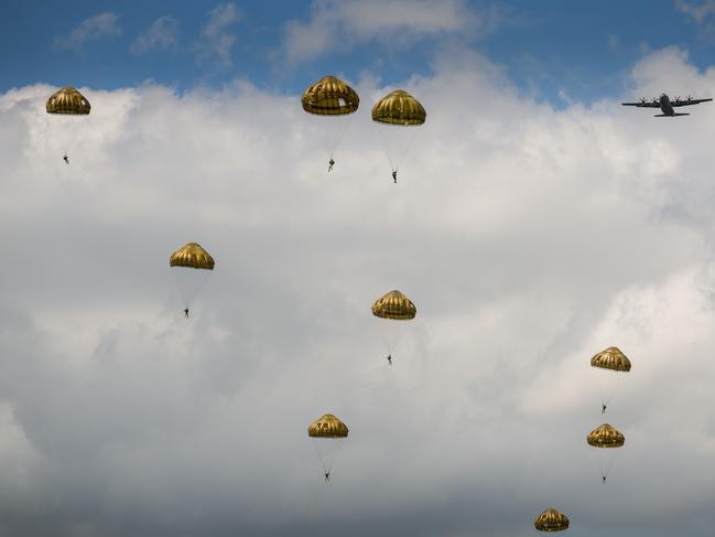 Paratroopers from the British, Belgian, Canadian and US military take part in a parachute drop in the fields of Sannerville, France. Picture: Getty Images