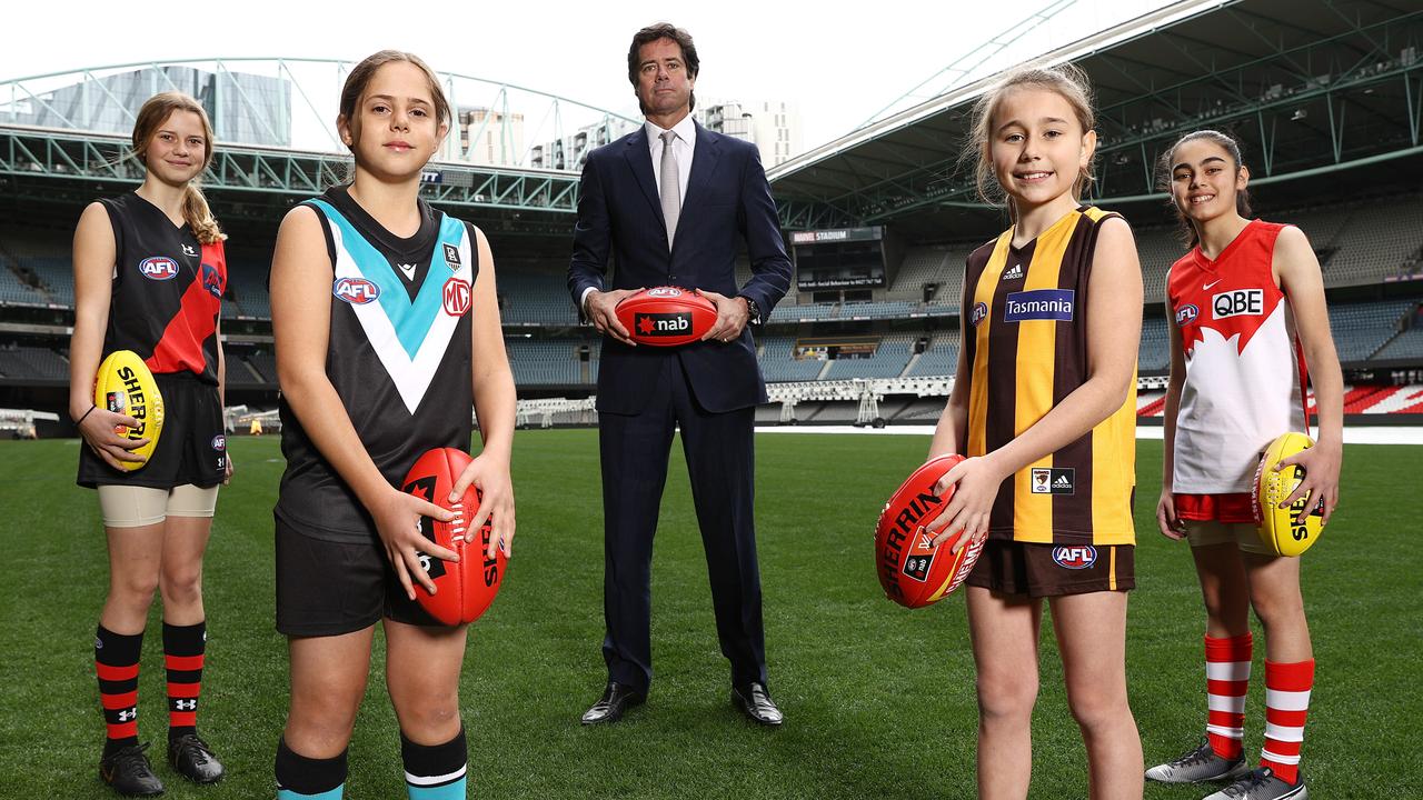 AFL Gillon McLachlan announces for the 2022-23 season every AFL club will have an AFLW team, with youngsters Nora Don (Essendon), Fadilla Taleb (Port Adelaide), Leni Burgoyne (Hawthorn) and Layla Rabah. Picture: Michael Klein