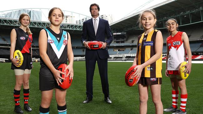 AFL Gillon McLachlan announces for the 2022-23 season every AFL club will have an AFLW team, with youngsters Nora Don (Essendon), Fadilla Taleb (Port Adelaide), Leni Burgoyne (Hawthorn) and Layla Rabah. Picture: Michael Klein