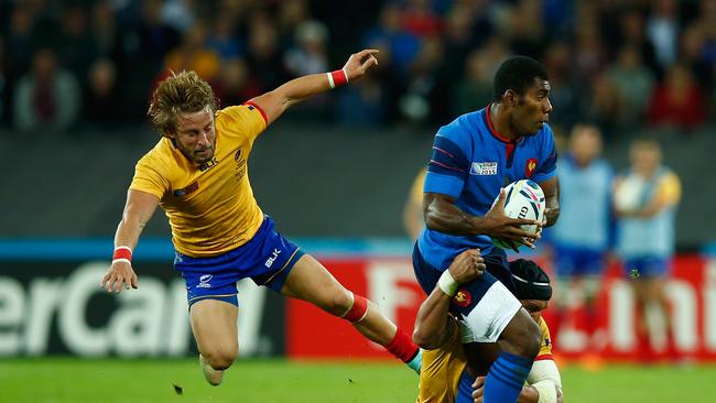 Noa Nakaitaci of France is tackled by Valentin Ursache and Florin Surugiu of Romania.