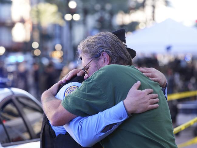 Edward Bruski, right, hugs New Orleans police officer Zachary Stevenson at the scene where a vehicle drove into a crowd on New Orleans' Canal and Bourbon Street. Picture AP/Gerald Herbert