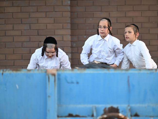 Young members of the Jewish community watch on. Picture: Tony Gough