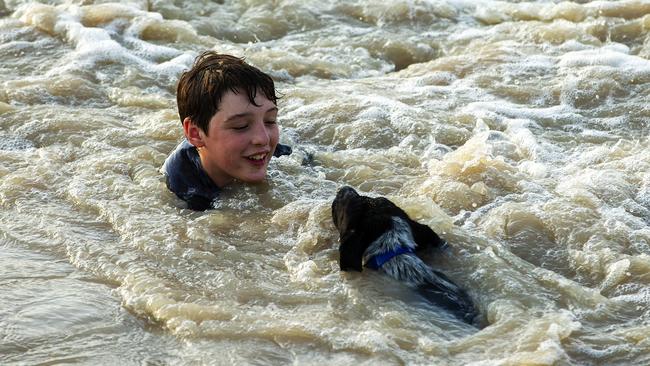 A boy swims with his dog at Brewarrina Weir. Picture: Jenny Evans/Getty Images