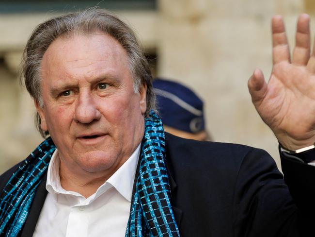 (FILES) French actor Gerard Depardieu waves as he arrives at the Town Hall in Brussels for a ceremony as part of the 'Brussels International Film Festival' (Briff) on June 25, 2018. The trial of French film legend Gerard Depardieu, who is charged with rape and is facing a litany of other sexual assault claims, is to open on October 28, 2024. (Photo by THIERRY ROGE / BELGA / AFP) / Belgium OUT