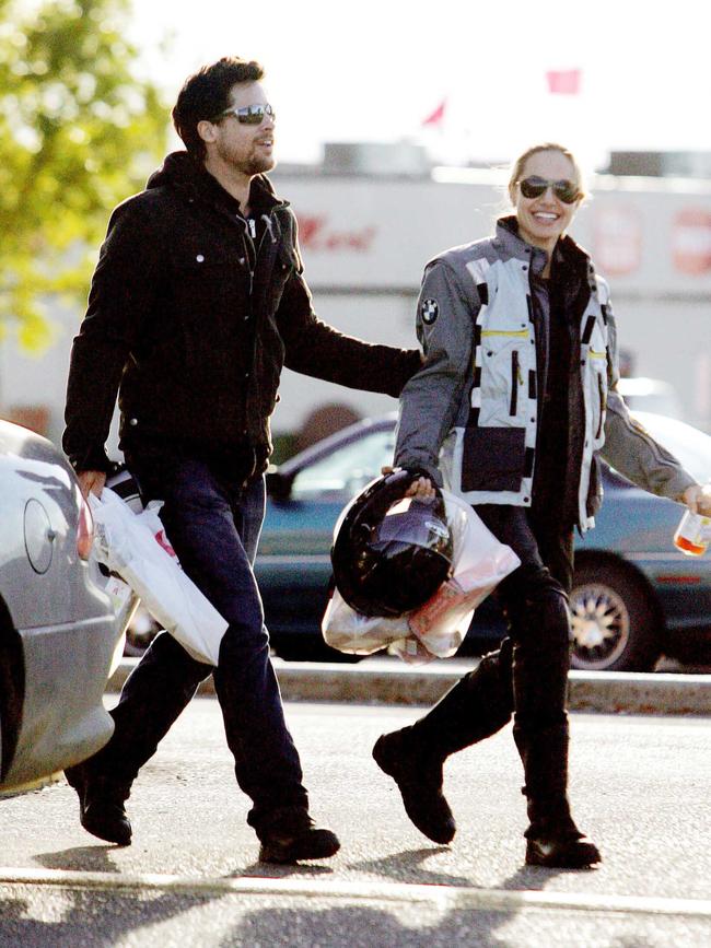 In one of the first pictures released of them as a couple Brad Pitt and Angelina Jolie finally make their romance public as they head out on his and hers motorcycles in Edmonton, Canada. The couple seemed very happy together as they headed to a local safeway supermarket and picked up supplies. As they left the store and headed back to their bikes Brad held Angelina’s arm and the couple shared a joke. After loading up Jolie had some trouble getting her bike started but with a little help from Brad they were soon on their way home. Picture: Splash