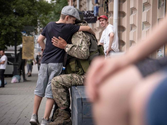 A young boy hugs a member of Wagner group in Rostov-on-Don, on June 24. Picture: AFP