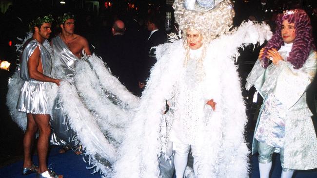 John at his 50th birthday extravaganza with David Furnish (in purple wig). Picture: Getty Images