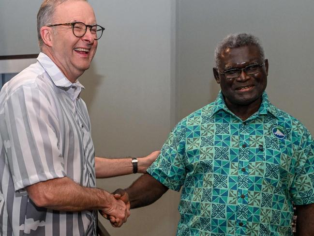 Australia's Prime Minister Anthony Albanese (L) greets Solomon Islands Prime Minister Manasseh Sogavare (R) during a bilateral meeting at the Pacific Islands Forum (PIF) in Suva on July 13, 2022. (Photo by Joe Armao / POOL / AFP)