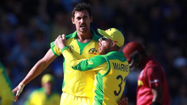 Mitchell Starc is congratulated during his five-wicket haul by David Warner.